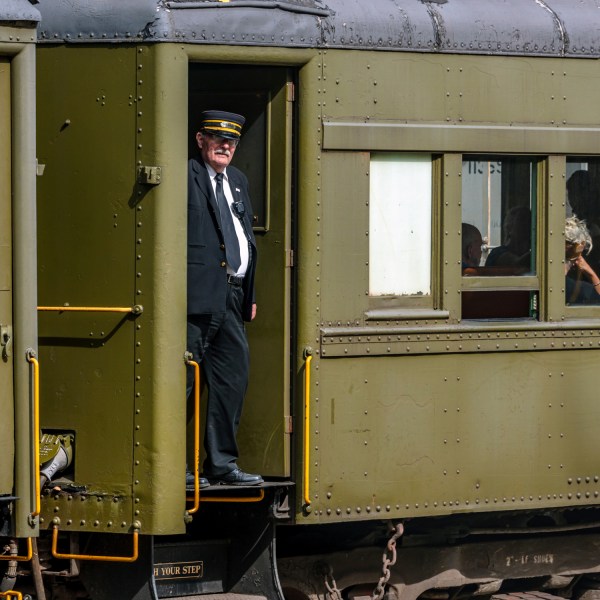 a train is parked on the side of a building