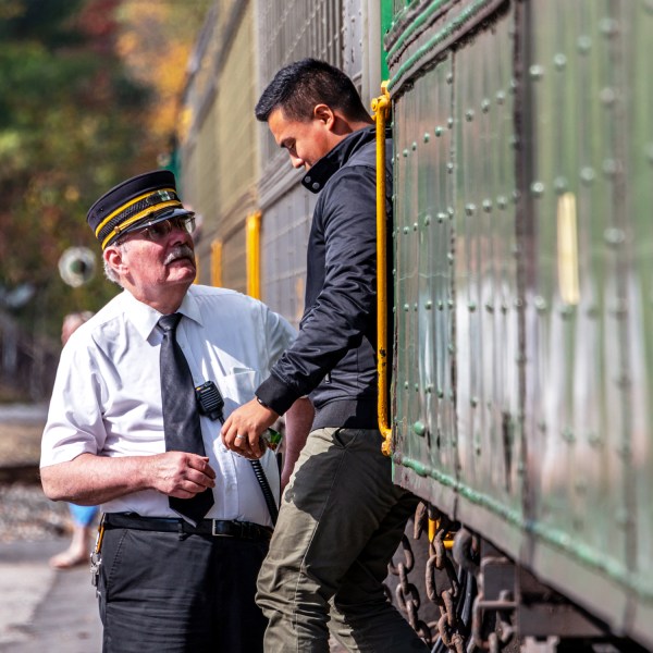 a man standing next to a train