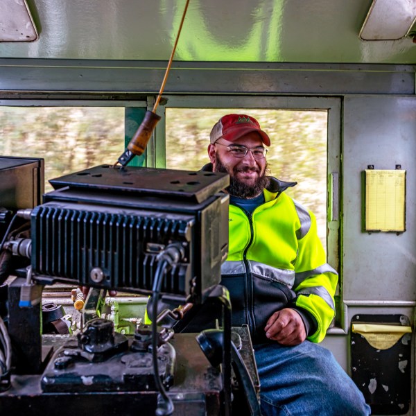 a person standing next to a suitcase
